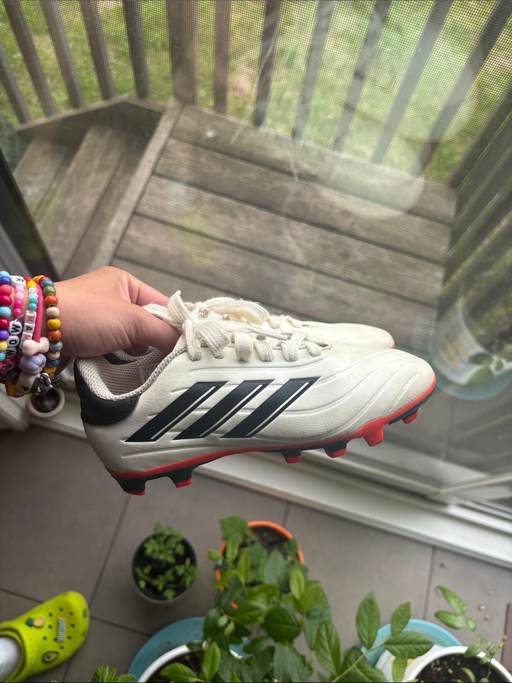 adidas kids White Soccer shoes with Black Stripes and Red Soles